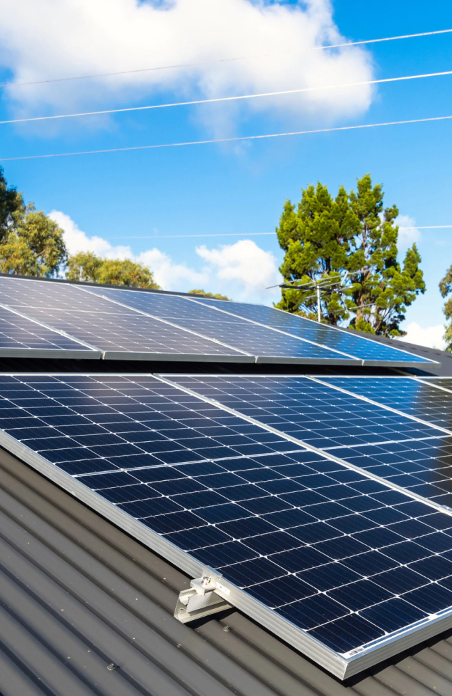black solar panel under blue sky and white clouds